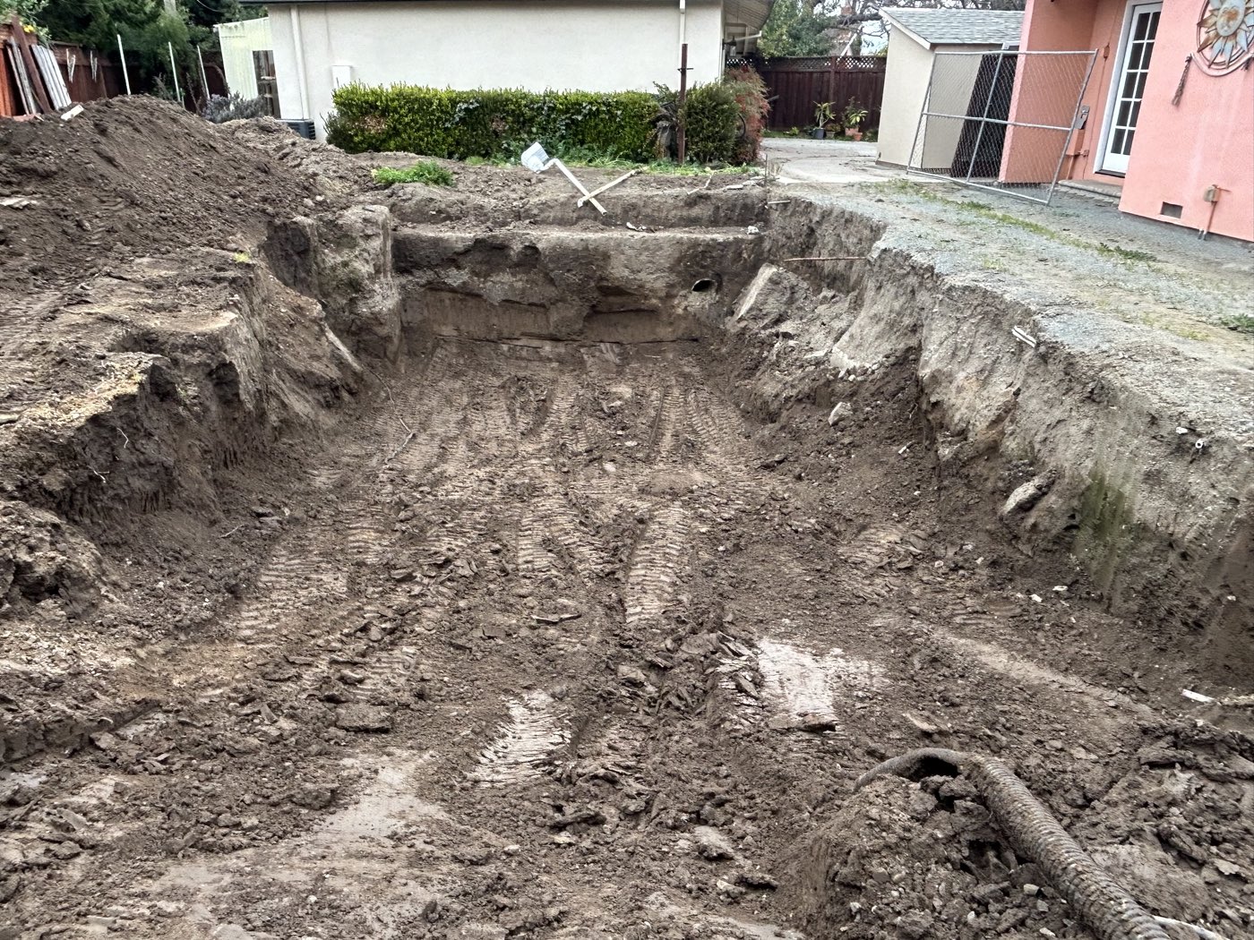 Deep pool excavation with clean dirt walls, before backfill
