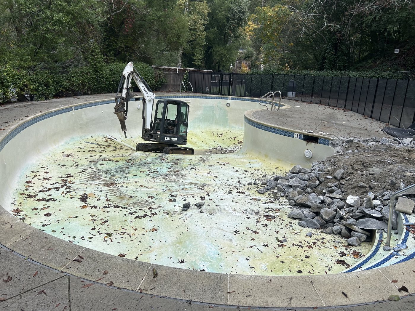 Full swimming pool at the start of demolition